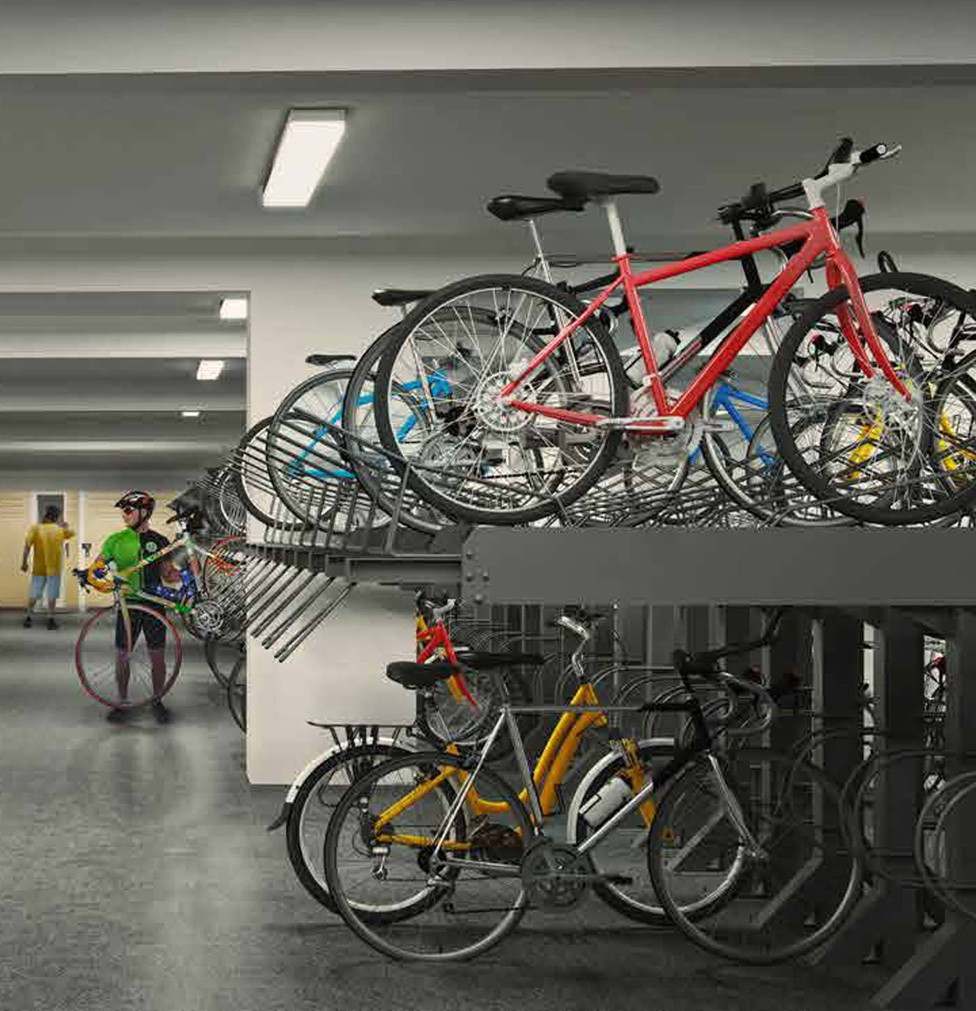 A parking garage with bikes on two-tiered racks. A red bike is on the upper rack, a yellow and silver bike below. Two cyclists are in the background.